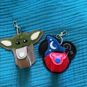 Grogu and Sorcerer Mickey Keychain Set to hold Disney park mouse ears